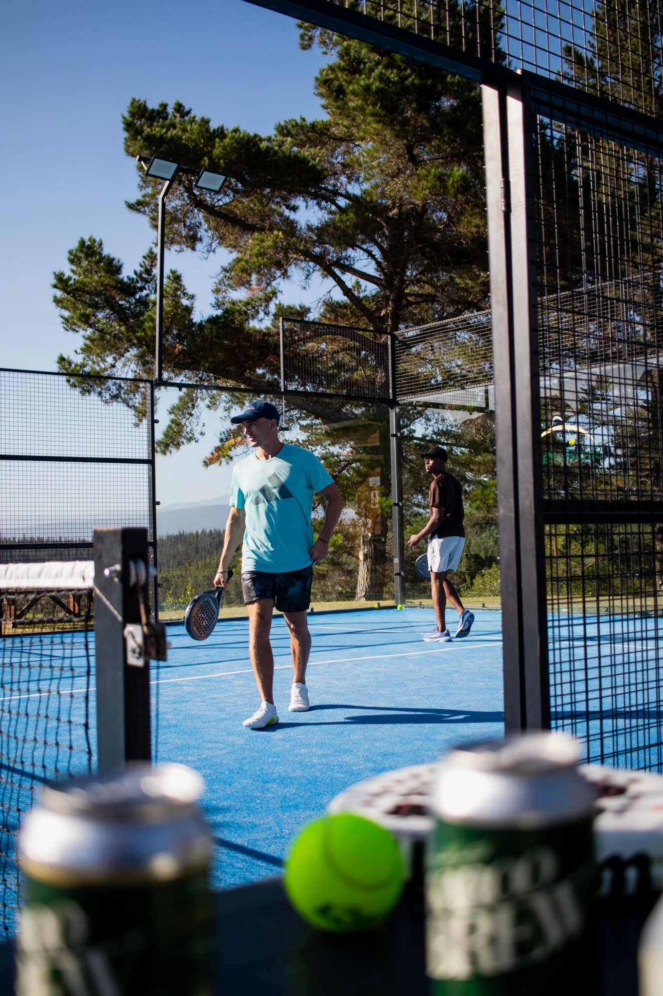 Zwei Spieler auf einem blauen Padel-Court